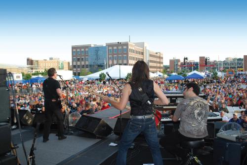 a woman standing on a stage in front of a crowd at Holiday Inn Dubuque/Galena by IHG in Dubuque