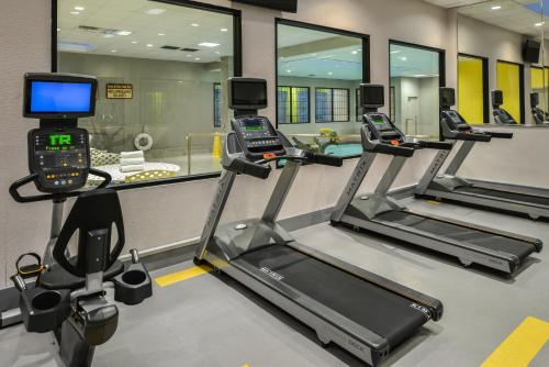 a gym with three treadmills and a treadmill at Holiday Inn Dallas-Richardson by IHG in Richardson