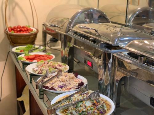 a buffet with several plates of food on a table at Classic Street Hotel in Hanoi