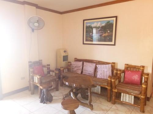 a room with benches and a table and a fan at VRC Resort in Almeria