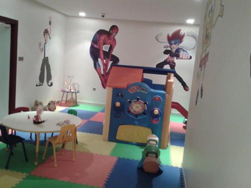 a childs room with a superhero mural on the wall at أسوار للشقق المخدومة in Al Khobar