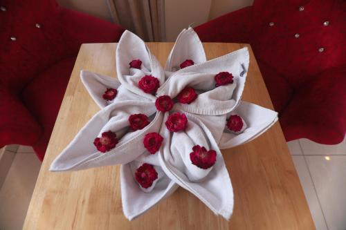 a table with a white flower on top of it at Indira Nikunj Rubystone Exotic in Rishīkesh