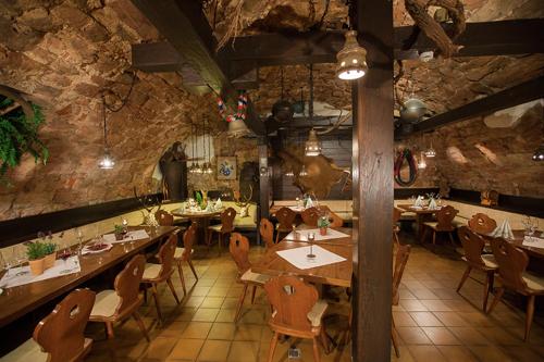 a dining room with tables and chairs in a building at Hotel-Restaurant Pfälzer Hof in Edenkoben