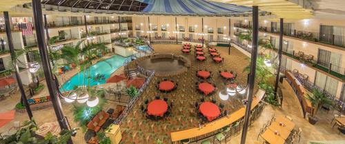 an overhead view of a mall with a pool and tables at Holiday Inn Des Moines-Airport Conf Center by IHG in Des Moines