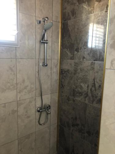 a shower with a shower head in a bathroom at moonlight hotel in Alanya