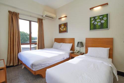 Postel nebo postele na pokoji v ubytování Kepong Hotel