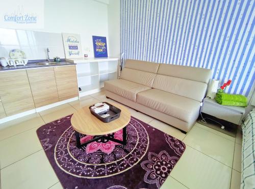 a living room with a couch and a table at Comfort Zone Premium Guesthouse @ Evo Bangi in Bangi