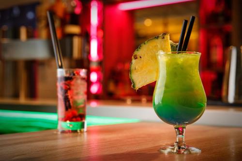 a drink sitting on a wooden table next to another drink at Holiday Inn Düsseldorf City – Toulouser Allee by IHG in Düsseldorf
