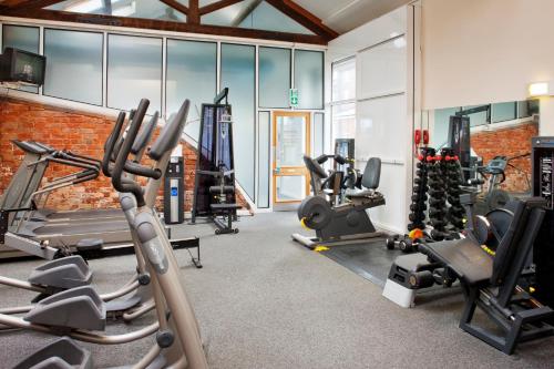 a gym with treadmills and exercise equipment in a building at Holiday Inn Ellesmere Port/Cheshire Oaks by IHG in Ellesmere Port