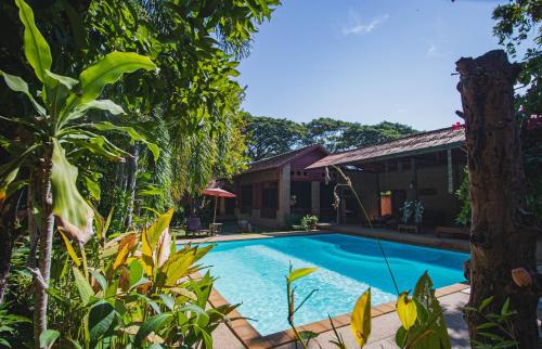 a swimming pool in front of a house at Joy's House & Tour in Chiang Mai