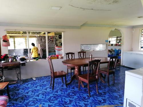 a dining room with a table and chairs at Mulu Diana Homestay in Mulu