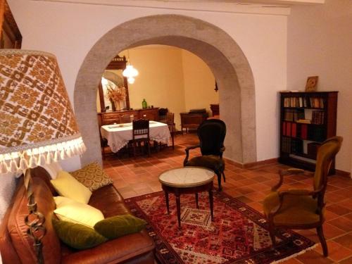 a living room with a couch and a table at Maison de caractere in La Chapelle-sur-Furieuse