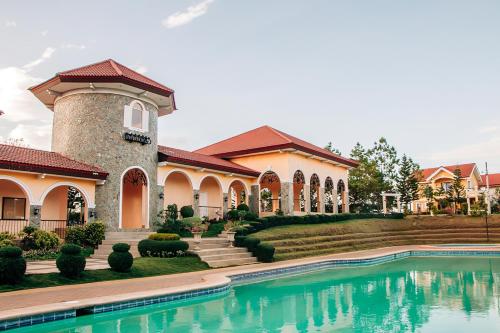 een groot huis met een zwembad ervoor bij Perfect staycation for families, friends, business travelers and tourist in Calacapan