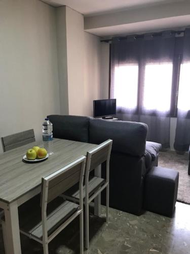 a living room with a table and a couch at APT4 Encantador al Centre de Vic APTGARBI in Vic