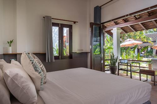 Giường trong phòng chung tại Sanctuary Hotel Luang Prabang