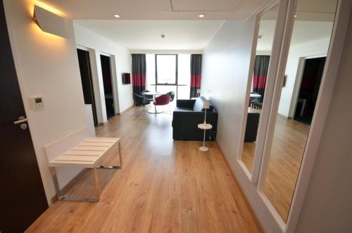 a living room with a couch and a table at Holiday Inn Dijon Toison D'or by IHG in Dijon