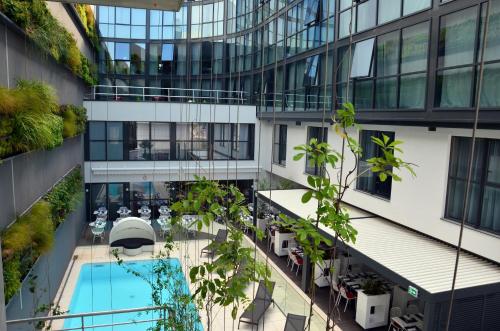 an overhead view of a building with a swimming pool at Holiday Inn Dijon Toison D'or by IHG in Dijon