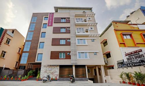 a building with two motorcycles parked in front of it at Treebo Trend Galaxy Suites Mathikere in Bangalore