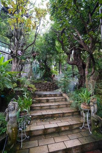 a set of stairs in a garden with trees at Treescape Resort Chiangmai in Chiang Mai