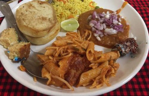 a plate of food with a sandwich and french fries at Hotel Oasis in Morogoro
