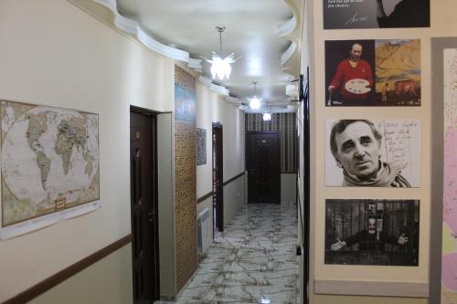 a hallway with posters and pictures on the walls at Arm Hostel in Yerevan