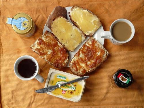 a plate of toast with two cups of coffee and two cups of coffeeastery at Antico Plaza Hotel in Taubaté