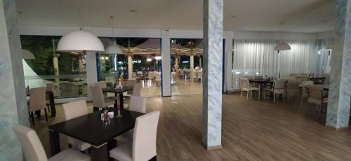 a restaurant with tables and chairs and a dining room at Hotel Shipka Beach in Sunny Beach