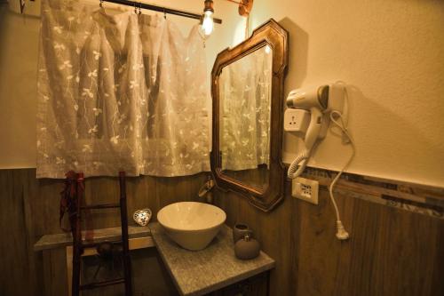 a bathroom with a sink and a mirror at Il Borgo del Castello in Cremolino