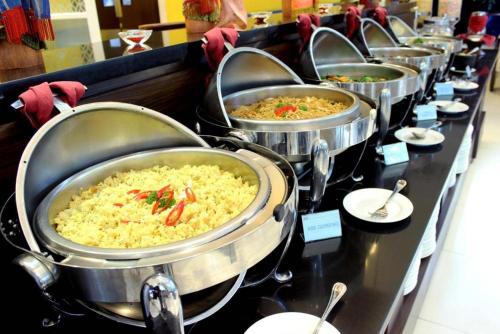 a row of pots filled with food on a table at Days Hotel Jaipur Tonk Road By Wyndham in Jaipur