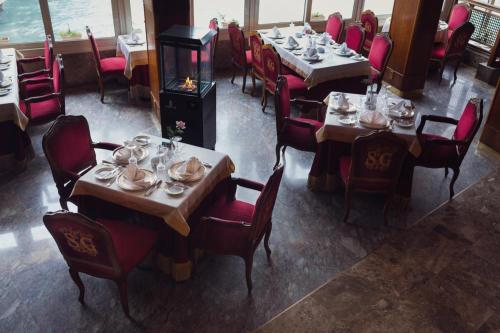 a dining room with tables and chairs with dishes on them at San Giovanni Stanly Hotel in Alexandria