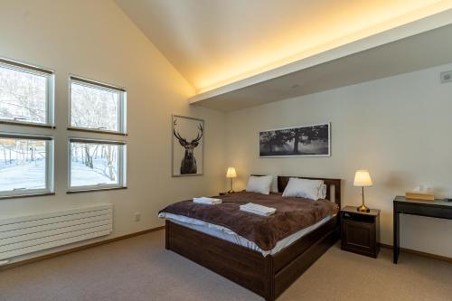 Ένα ή περισσότερα κρεβάτια σε δωμάτιο στο Iguru Ski Chalet - walking distance to Rusutsu Resort