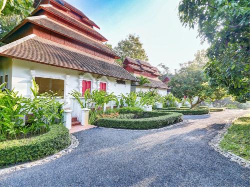 a house with a road in front of it at MonPanaNont Wellness Resort & Spa in Mae Taeng