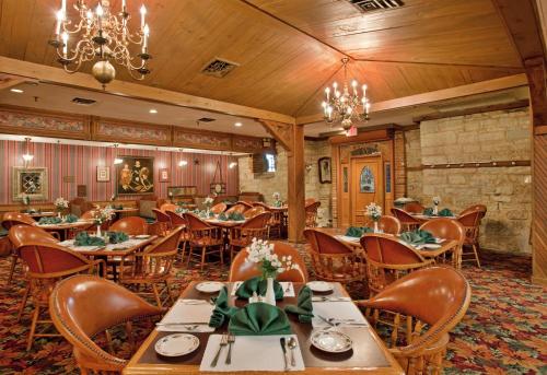 a dining room with tables and chairs and a chandelier at Holiday Inn At Six Flags Saint Louis, an IHG Hotel in Eureka