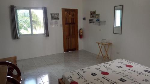 a room with a bed and a window at Kathleens Vacation Place in Moalboal