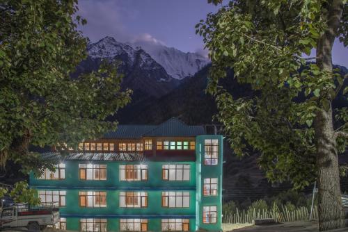 a rendering of a building with mountains in the background at Kinnor Retreat in Sāngla
