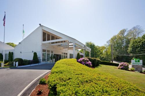 a white building with a sign in front of it at Hotel Cape Cod in Falmouth