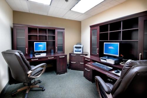 an office with two computer desks with chairs and two monitors at Holiday Inn - Fort Myers - Downtown Area by IHG in Fort Myers