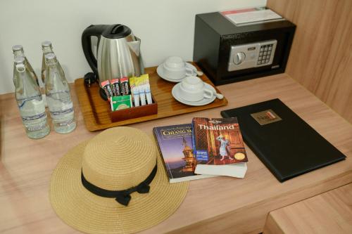 a straw hat sitting on top of a table with a clock at Nap in Chiangmai in Chiang Mai