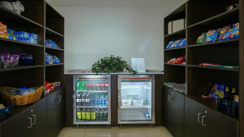 a refrigerator in a room with lots of shelves at Holiday Inn - Fort Myers - Downtown Area by IHG in Fort Myers