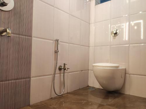 a bathroom with a toilet and a shower at Hotel Adarsh in Aurangabad