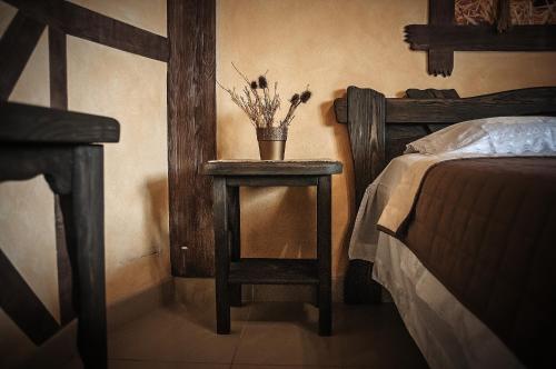 a bedroom with a bed and a table with a night stand at Avto Spa in Khmelʼnytsʼkyy