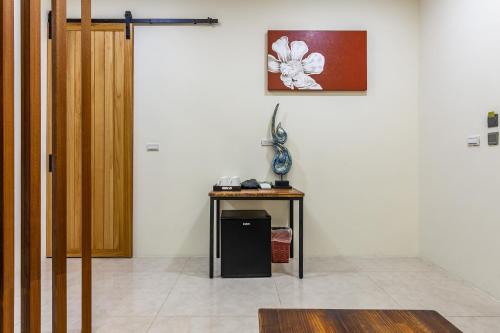 a room with a table and a picture on the wall at Mambo Boutique Hotel in Hengchun