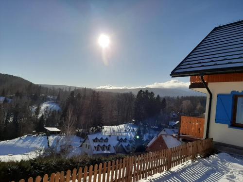a winter view of a snow covered mountain with the sun at Kolorowe Karkonosze in Przesieka