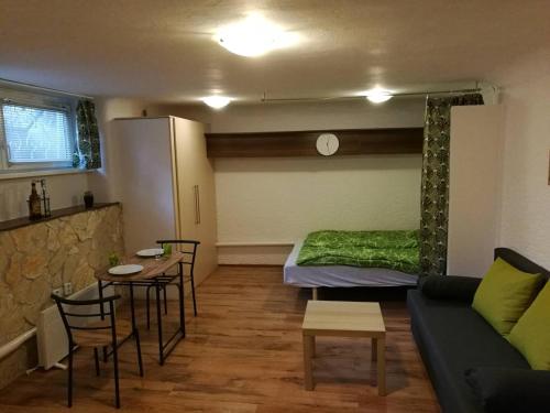 ein Wohnzimmer mit einem Sofa und einem Tisch in der Unterkunft City Center Studio Apartman in Pécs
