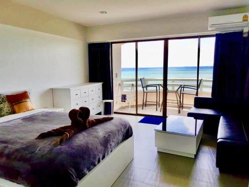 a bedroom with a bed and a view of the ocean at VIP CONDO RAYONG 343 in Rayong
