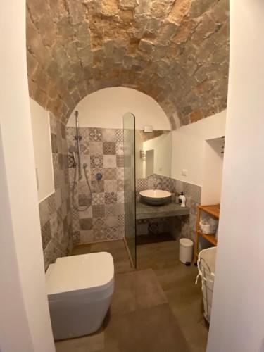 a bathroom with a shower and a toilet and a sink at Greta's House Pizzo in Pizzo