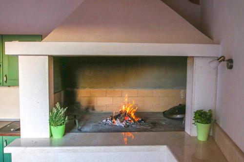 a brick oven with a fire in it at Villa Natasha in Makarska