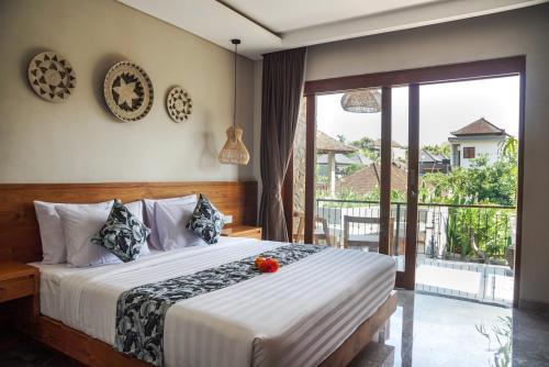 A bed or beds in a room at Bisma Terrace Suite Ubud