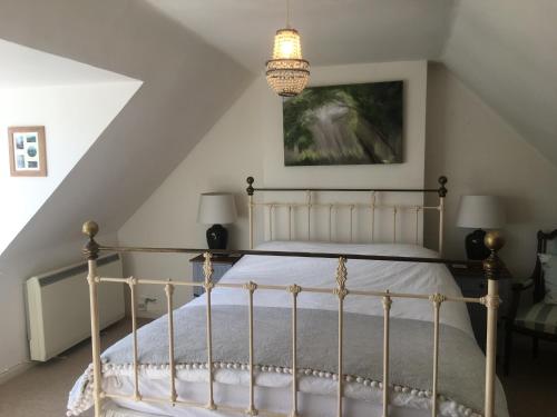 a bedroom with a bed in a attic at The Thatched Cottage in Truro