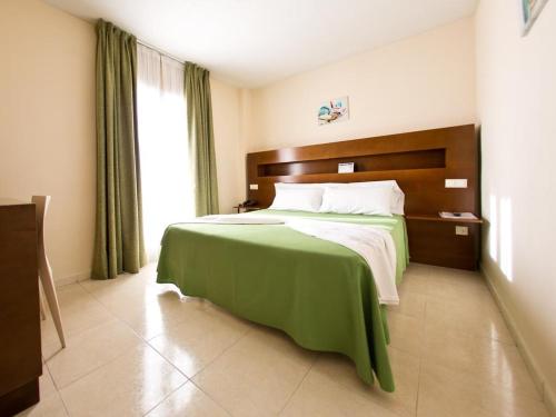 Postel nebo postele na pokoji v ubytování Hostal San Marcos